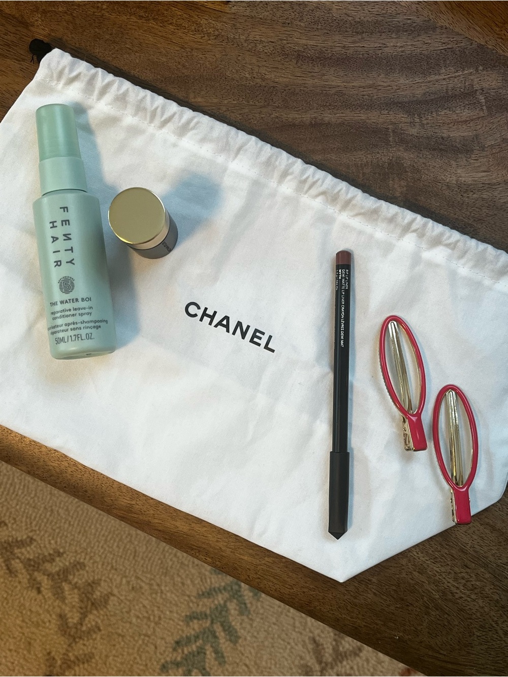 Westman Atelier highlighter, Fenty hair conditioner spray, Haus Lab lip liner+